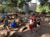 NWPS play yard Young children playing in an outdoor sand and water area with a variety of loose parts.