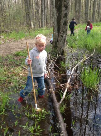 Photo by Tina Pretzer Children spend time outdoors daily, including searching for frogs in spring.
